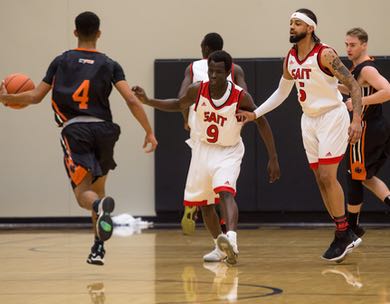 Emmanuel Enabu (#9) and Enoque Michel (#5) defend against Langara