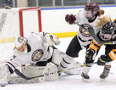 MacEwan goalie Sandy Heim turns aside an Olds shot under pressure during a recent contest (photo by Len Joudrey)